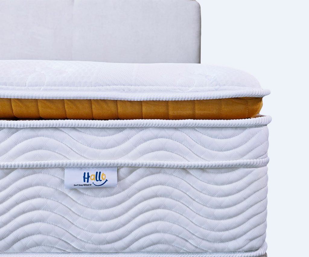 Hallo Lovely Morning | Wake Up Recharged 6 Front view of a Hallo Premium Gold mattress with a Hallo logo tag in view