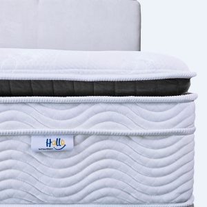Partial front view of Cool Grey Hallo mattress, with Hallo logo tag in view